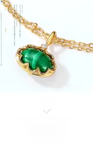 Macro view of vintage oval malachite pendant in 925 silver with gold plating