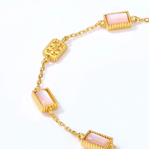 Macro detail of vintage 925 silver bracelet with pink shell and gold embossed links