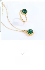 Macro shot of green agate ring and necklace with crown setting and gold plating
