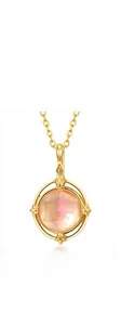 Detail of pink crystal pendant with rose gold chain and vintage compass claw setting