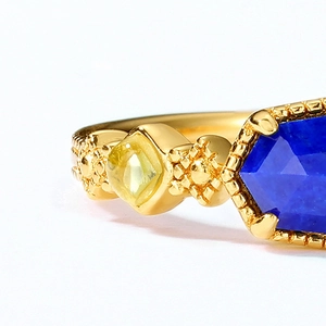 Macro shot of 925 silver ring with hexagonal lapis lazuli and textured 10K gold finish