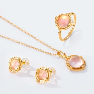 925 silver jewelry set with pink enamel bird and round peach gemstones on white background