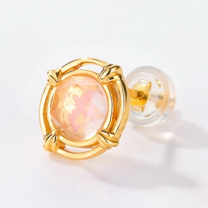 Macro view of a 925 silver gold-plated stud earring featuring a faceted pink quartz stone