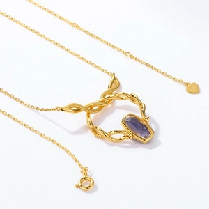 Detailed close-up of S925 heart charm on gold chain with purple gemstone pendant