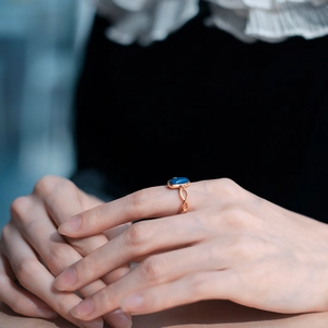 Close-up of a vintage rose gold twisted ring featuring a rectangular blue lapis stone