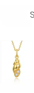 Close-up of a 925 silver conch pendant with 10K gold plating and white cubic zirconia