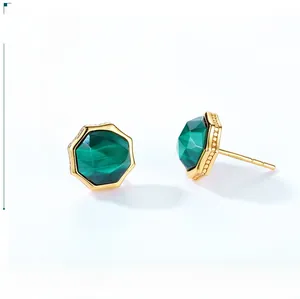 Detail of octagonal malachite stud earrings with gold beaded edges and polished finish