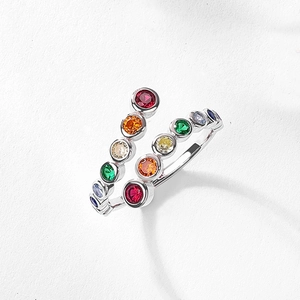 Close-up of dual-row rainbow cubic zirconia stones on a polished silver open ring
