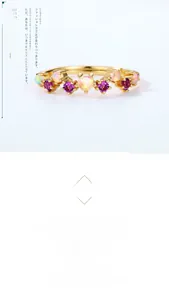 Macro detail of gold ring featuring alternating amethyst and opal stones in claw setting