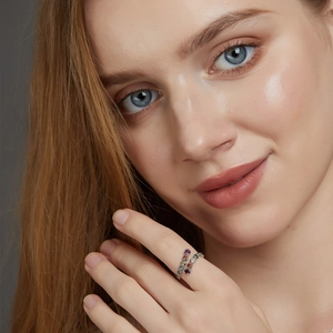 Close-up of a silver spiral open ring with vibrant multi-color zircon stones on finger