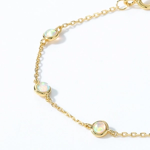 Luxurious gold S925 silver bracelet featuring three round synthetic opal gemstones