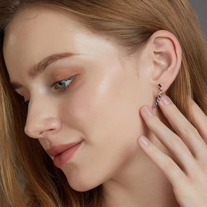 Close-up of rainbow zircon ear crawlers in S925 sterling silver on a female ear