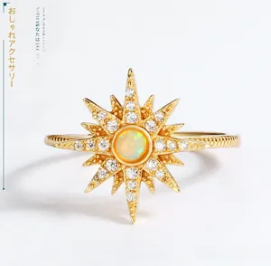 Macro view of sunburst gold ring featuring opal center and micro-inlaid zirconia stones