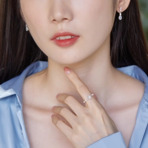 Close-up of S925 silver ring and earrings set with pear-cut opal stones and diamonds