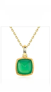 Detail of square gold pendant with green agate stone and vintage beaded edge texture