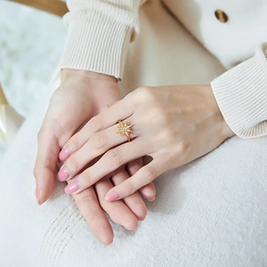 Luxurious sunburst S925 silver ring with opal stone and gold finish on model's hand