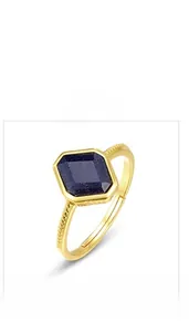 Macro detail of adjustable gold-plated ring featuring a sparkling blue sandstone gem