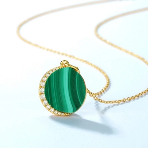 Elegant gold necklace with malachite stone pendant and sparkling zircon accents