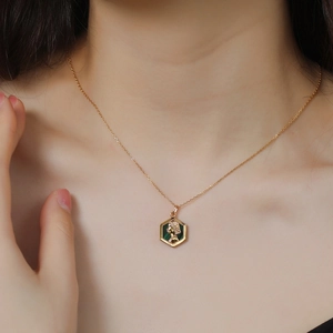 Detail of vintage 925 silver gold-plated necklace featuring a queen cameo malachite pendant