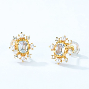 Elegant S925 silver studs with blue topaz and pearls in a vintage gold setting