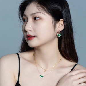 Detail of S925 silver butterfly necklace with green malachite and double-layer gold chain