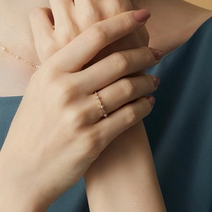 Elegant gold S925 sterling silver ring with delicate shell pearls shown on a model