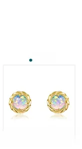 Detail view of round opal stud earrings featuring golden twisted metal borders and iridescent stones