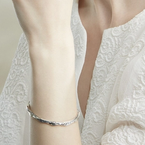 Japanese minimalist silver twist cuff bracelet with vintage textured finish on wrist
