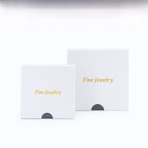 Close-up of white jewelry gift boxes with gold Fine Jewelry foil stamping detail