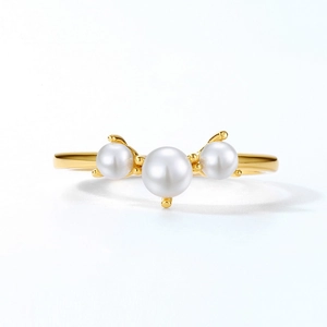 Elegant gold ring with three white pearls and minimalist open geometric design