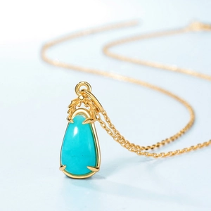 Golden S925 silver necklace featuring a teardrop amazonite leaf pendant on blue background
