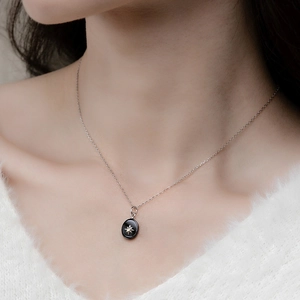 Collier en argent S925 avec pendentif ovale noir et motif d'étoile sur un mannequin