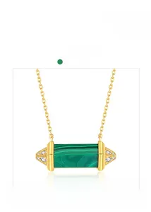 Detail view of a green malachite pendant on a gold chain necklace with micro diamonds