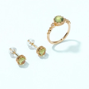 Vintage gold vermeil jewelry set with peridot green stones and crown-style carvings