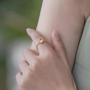 Detailed close-up of a vintage crown rose quartz ring with an intricate rope band