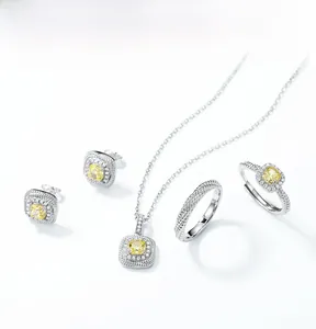 Macro shot of 925 silver jewelry set with yellow cushion cut stones and halo detail