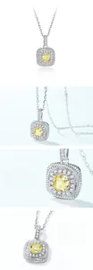 Macro shot of square yellow carbon diamond pendant with white zircon halo on silver chain