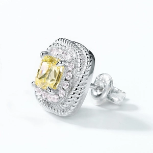 Close-up of S925 silver earring featuring a radiant cut yellow gemstone with halo setting