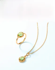Detail of peridot pendant necklace and ring with unique coral texture gold plating