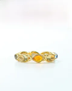 Detailed macro view of S925 silver ring with multi-color teardrop gemstones and engravings
