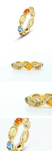 Macro detail of S925 silver gold-plated ring featuring multi-color gemstones and leaf motifs