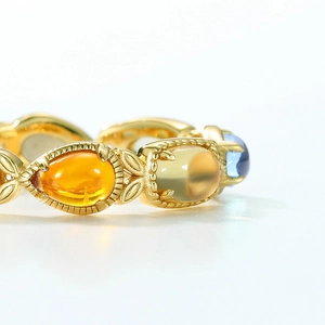 Exquisite gold multi-color gemstone ring with floral engraving and colorful oval stones