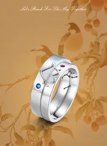 Detailed macro view of S925 sterling silver nesting rings with bird pattern and gemstones