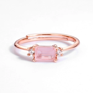 Detail of rose gold open ring featuring a rectangular pink gemstone and accent diamonds