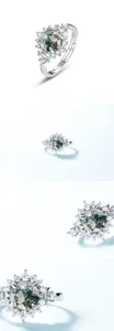 Macro detail of S925 silver ring featuring green moss agate stone and crystal accents