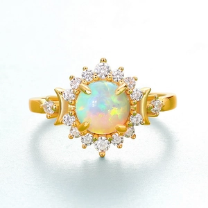 Macro shot of gold sun and crescent moon ring featuring opal and pavé cubic zirconia