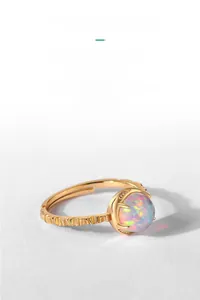 Detailed macro shot of vintage gold opal ring with wavy band and shimmering zircon accents