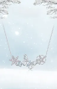 Detailed close-up of S925 silver necklace with blue topaz and hollow butterfly charm