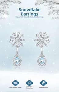Detail of 925 silver snowflake earrings with detachable light blue topaz drops