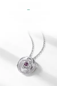 Detail shot of the silver rose pendant with alexandrite stone and small diamond accents